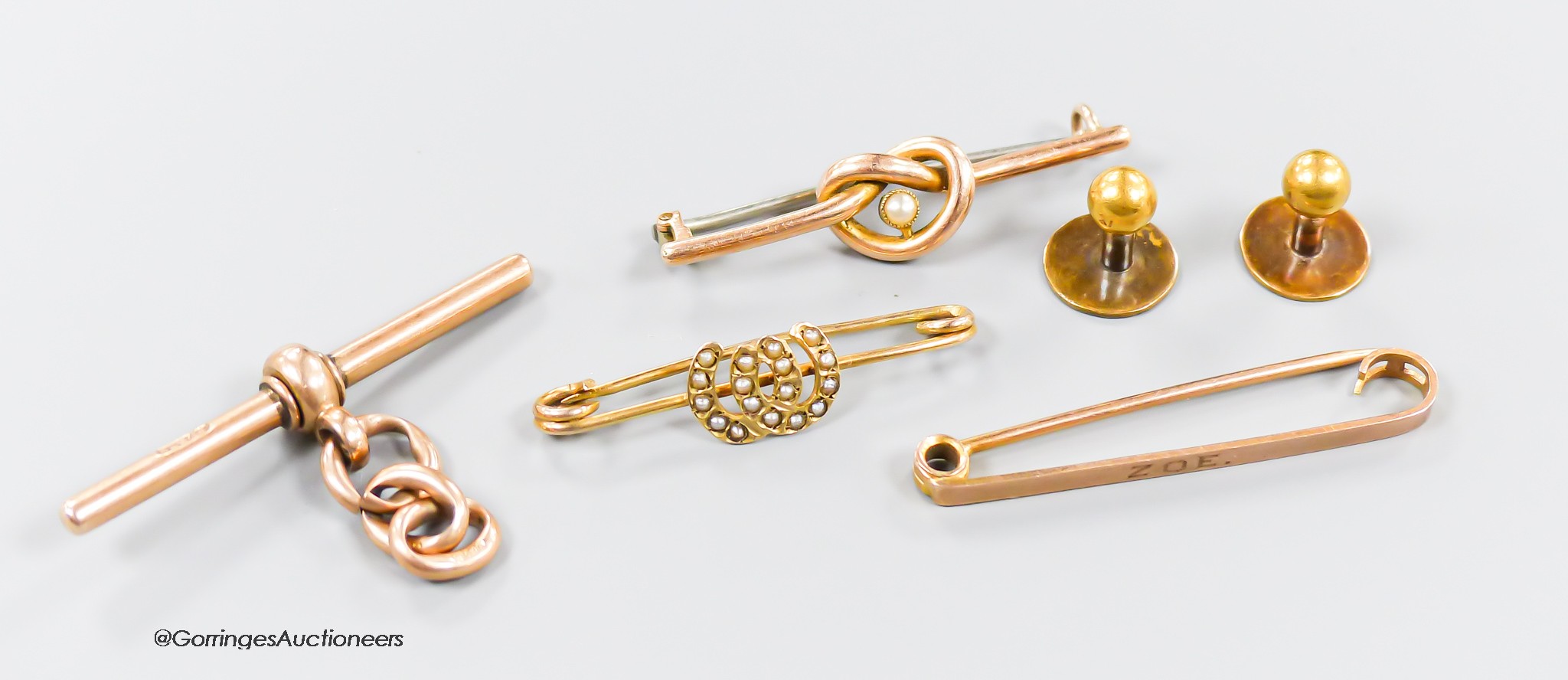 Two 9ct bar brooches and a9ct gold T-bar, gross 8.2 grams, a yellow metal and seed pearl bar brooch, gross 1.7 grams and two 15ct gold dress studs, 2.1 grams.